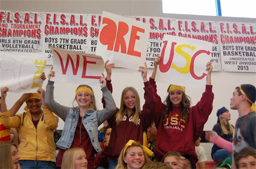 	 students holding signs which spell out "We are USC"